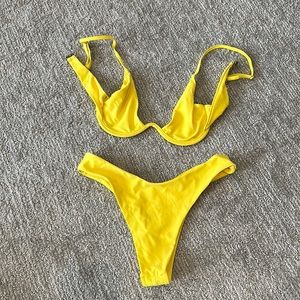 Never worn yellow bikini size medium, high leg cut bottoms,